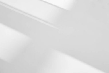 Abstract shadow and striped diagonal light background in office room  on white wall  from window.  Shadows dark gray and sunshine diagonal geometric effect overlay for backdrop and mockup desig