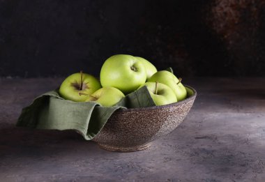 fresh organic green apples in a bowl