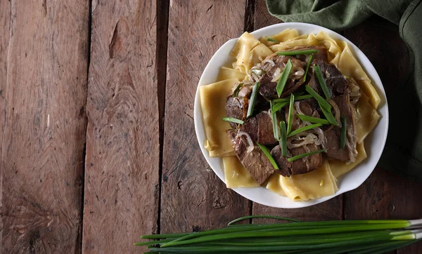 stock image national Kazakh dish beshbarmak on a wooden table