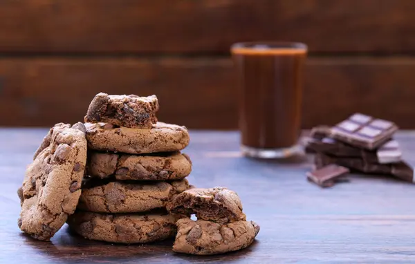 chocolate cookies with chocolate chips on a wooden table