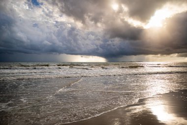 Denizin üzerindeki fırtına bulutları, bulutlar, kara bulutlar, denizde sağanak yağmur ve su yüzeyinde güzel deniz köpüğü..