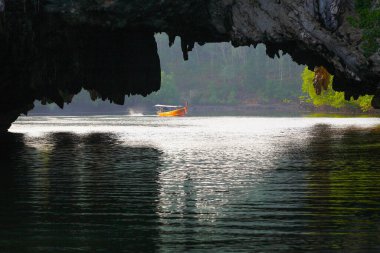 Tham Lod Yai (Grotto Cave) Jungle covered limestone cliffs at Phang Nga Bay.Thailand. clipart