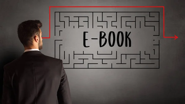 businessman drawing maze with E-BOOK inscription, business education concept