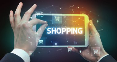El ele tutuşma tabletinin yakın plan fotoğrafı. Üzerinde para yazılı, online alışveriş konsepti var.