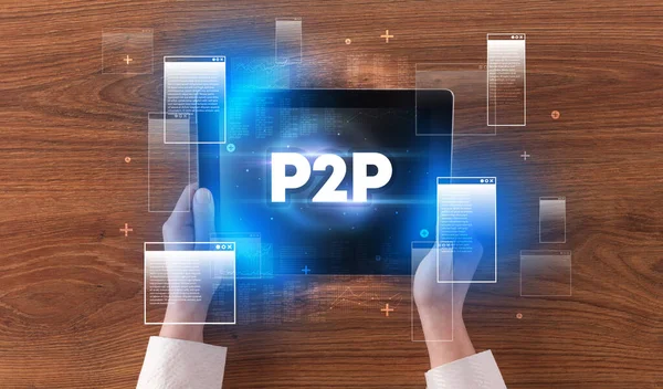 stock image Close-up of a hand holding tablet with P2P abbreviation, modern technology concept