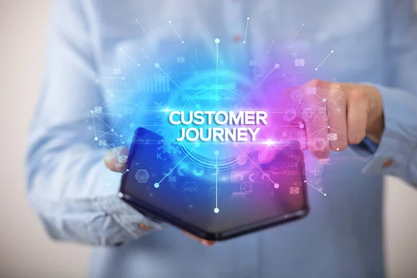 Businessman Holding Foldable Smartphone Customer Journey Inscription New Business Concept — Stock Photo, Image