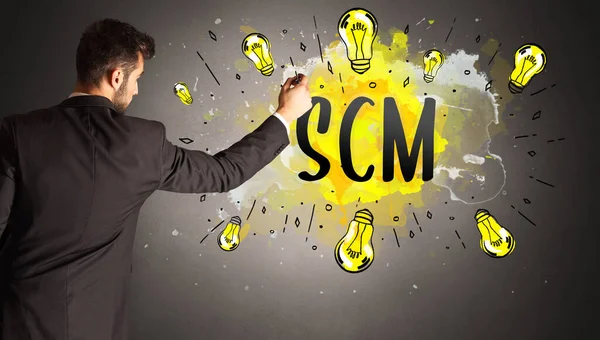 Businessman Drawing Colorful Light Bulb Scm Abbreviation New Technology Idea — Stock Photo, Image