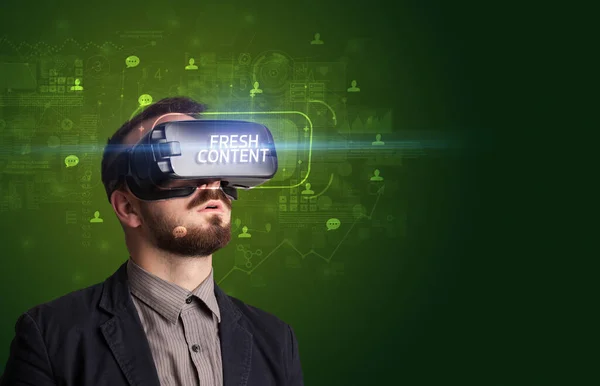 stock image Businessman looking through Virtual Reality glasses with FRESH CONTENT inscription, social networking concept