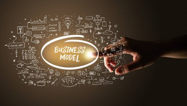 Hand touching BUSINESS MODEL inscription, hand drawn icons around, business plan concept