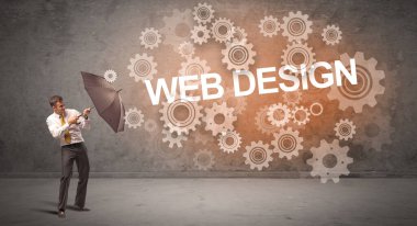 WeB DESIGN yazıtları ve teknoloji kavramından şemsiyeyle savunma yapan iş adamı