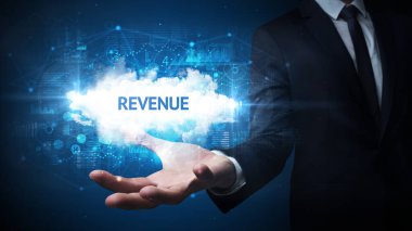 İş adamının elinde REVENUE yazıtları, başarılı iş konsepti