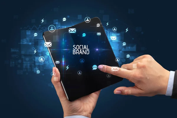 Businessman Holding Foldable Smartphone Social Brand Inscription Social Networking Concept — Stock Photo, Image