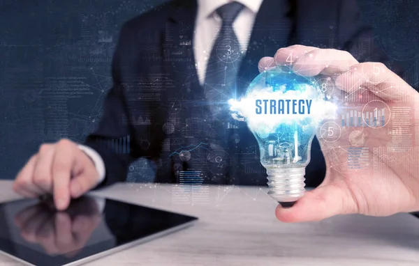 Empresário Segurando Uma Lâmpada Com Inscrição Estratégia Novo Conceito Negócio — Fotografia de Stock