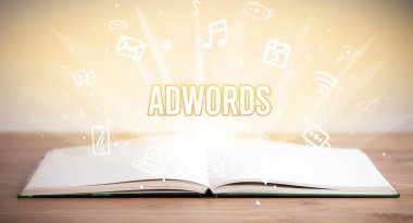 Opeen book with ADWORDS inscription, business concept