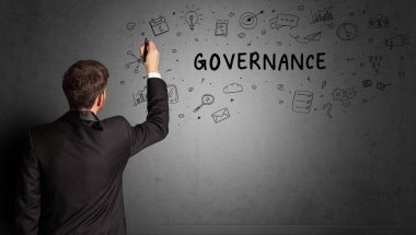 İş adamı GOVERNANCE yazıtları ve iş stratejisi konseptiyle yaratıcı bir fikir çizimi yapıyor.