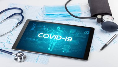 COVID-19 yazıtlı tablet bilgisayar ve doktor araçları, koronavirüs kavramı