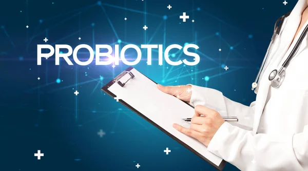 stock image Doctor fills out medical record with PROBIOTICS inscription, medical concept
