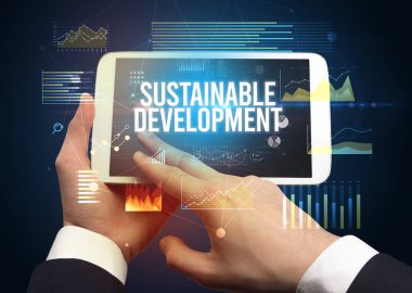 El ele tutuşmak tablet SUSTAINLE DEVELOPMENT yazıt, modern iş konsepti