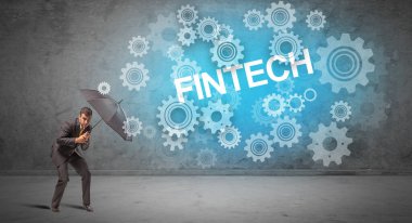 FINTECH yazıtları ve teknoloji kavramından şemsiyeyle savunma yapan işadamı