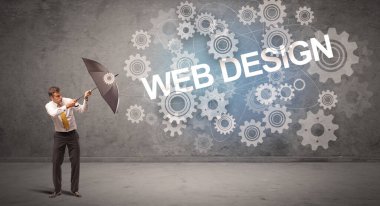 WeB DESIGN yazıtları ve teknoloji kavramından şemsiyeyle savunma yapan iş adamı