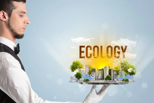 Waiter serving eco city with ECOLOGY inscription, renewabke energy concept
