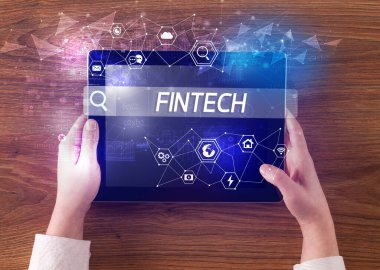 Bir tabletin yakın plan araması FINTECH yazıtları, yüksek teknoloji bilgisayar kavramı