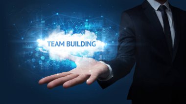 İş adamının eli Takım Binası yazısını tutuyor, başarılı iş konsepti