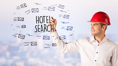 Handsome businessman with helmet drawing HOTEL SEARCH inscription, contruction sale concept clipart