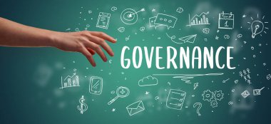 GOVERNANCE yazıtına işaret eden kırpılmış elin yakın çekimi, modern iş çözümleri kavramı