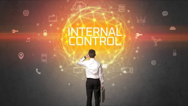 Rear view of a businessman with INTERNAL CONTROL inscription, online security concept