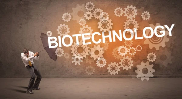 Businessman Defending Umbrella Biotechnology Inscription Technology Concept — Stock Photo, Image