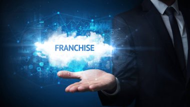 FRANCHISE yazıtlarını tutan İşadamı 'nın eli, başarılı iş kavramı
