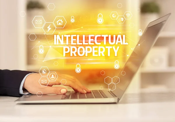 INTELLECTUAL PROPERTY inscription on laptop, internet security and data protection concept, blockchain and cybersecurity