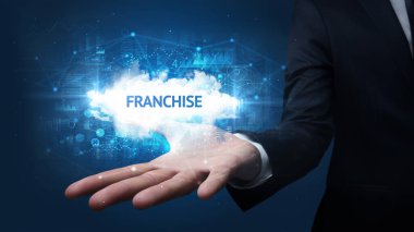 FRANCHISE yazıtlarını tutan İşadamı 'nın eli, başarılı iş kavramı