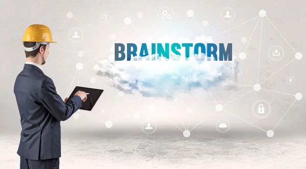Engineer working on a social media concept with BRAINSTORM inscription