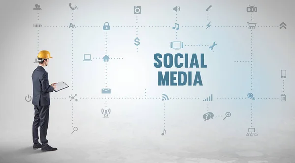 Engineer working on a new social media platform with SOCIAL MEDIA inscription concept