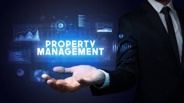 Mülkiyet Yönetimi yazıtlarını tutan İşadamı 'nın eli, iş başarısı kavramı