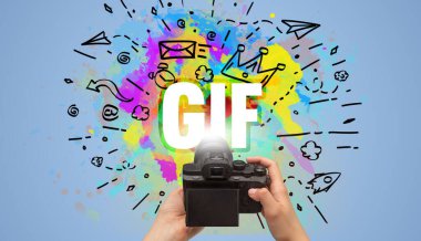 Close-up of a hand holding digital camera with abstract drawing and GIF inscription clipart