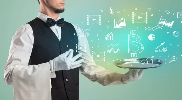 Handsome young waiter in tuxedo holding tray with bitcoin icons on tray, global market concept