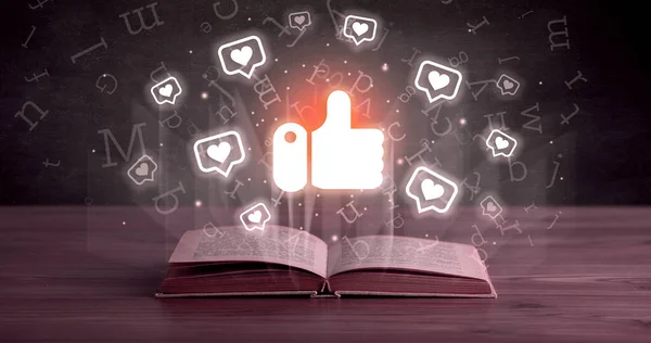 Open book with like icons above, social networking concept