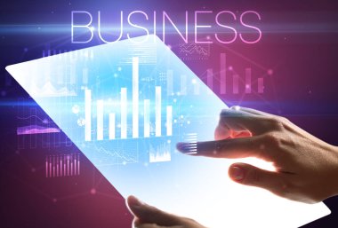 Üzerinde BÜYÜK yazıtları olan el ele tutuşan fütürist tablet, modern iş kavramı