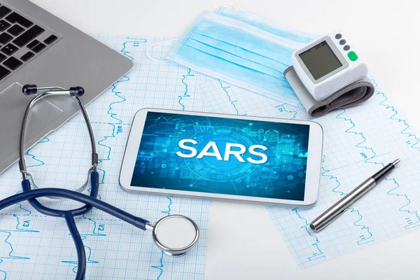 stock image Close-up view of a tablet pc with SARS abbreviation, medical concept