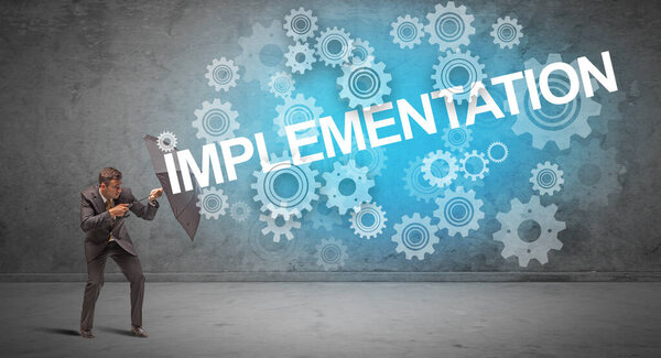 Бизнесмен, защищающийся зонтиком от имплантации, технологическая концепция