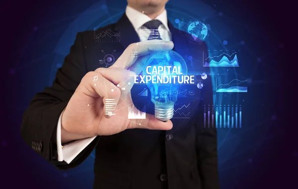 Businessman Holding Lightbulb Capital Expenditure Inscription Business Idea Concept — Stock Photo, Image