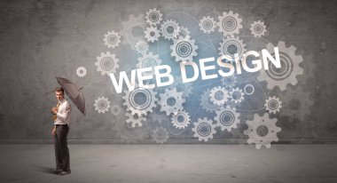 WeB DESIGN yazıtları ve teknoloji kavramından şemsiyeyle savunma yapan iş adamı