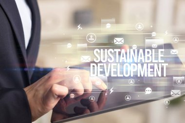 BİR tabletin yakın plan araştırması SUSTAINA DEVELOPMENT yazıt, modern teknoloji konsepti