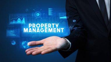 Mülkiyet Yönetimi yazıtlarını tutan İşadamı 'nın eli, iş başarısı kavramı