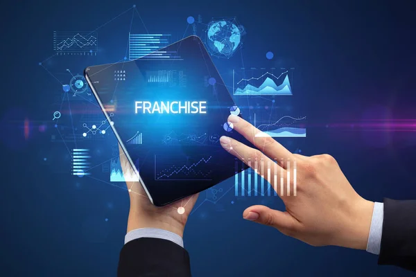 Businessman Holding Foldable Smartphone Franchise Inscription Successful Business Concept — ストック写真
