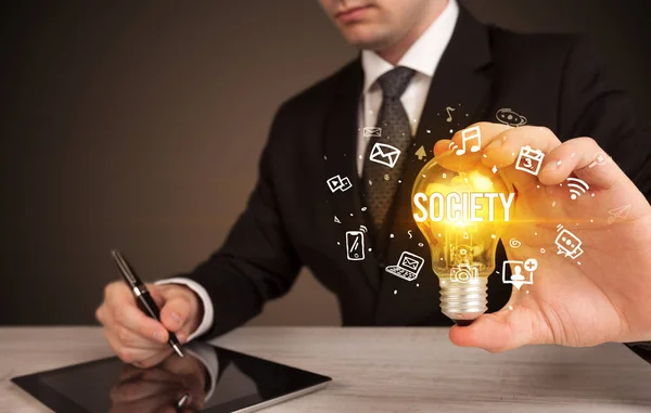 Businessman Holding Light Bulb Society Inscription Social Media Concept — Stock Photo, Image