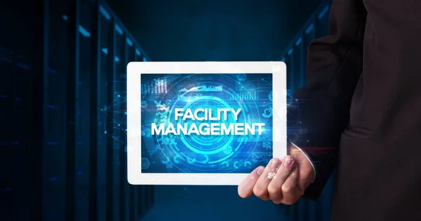 Young Business Person Working Tablet Shows Inscription Facility Management Business — Stock Photo, Image